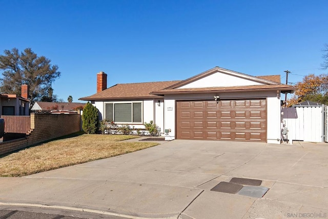 ranch-style house featuring a garage and a front yard