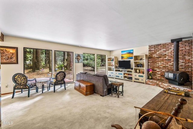 carpeted living room with a wood stove