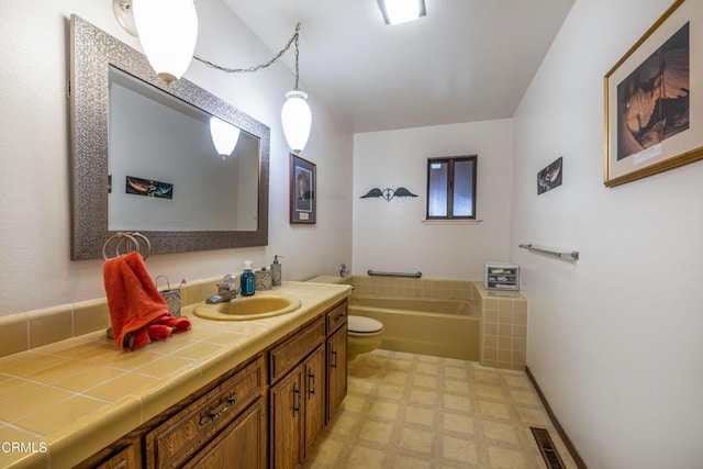 bathroom featuring vanity, a tub, and toilet