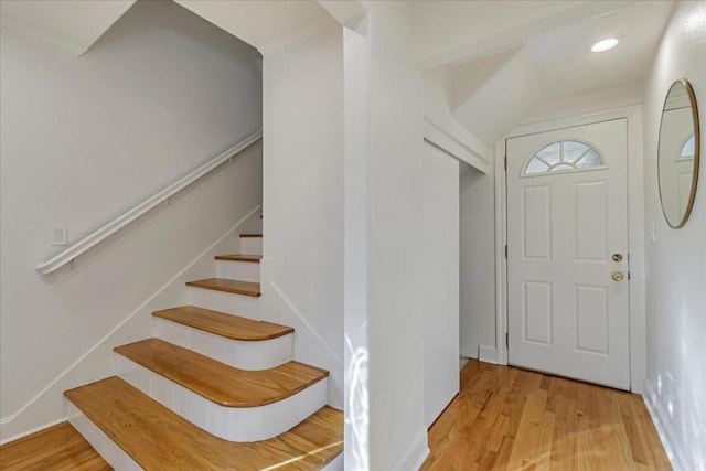 entrance foyer featuring ornamental molding and light hardwood / wood-style flooring