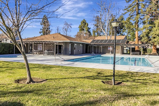 view of swimming pool with a pergola, a patio, and a lawn