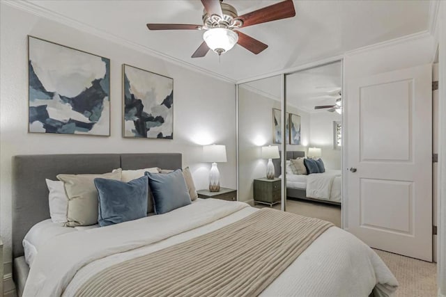 carpeted bedroom with crown molding, a closet, and ceiling fan