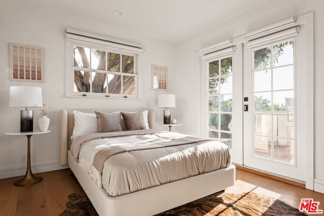 bedroom with hardwood / wood-style flooring and access to exterior