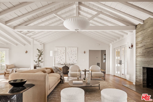 living room with french doors, wood-type flooring, high vaulted ceiling, a high end fireplace, and beam ceiling