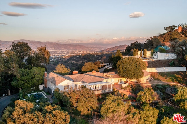 aerial view at dusk featuring a mountain view