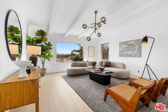 living room featuring a notable chandelier, beam ceiling, and light hardwood / wood-style flooring