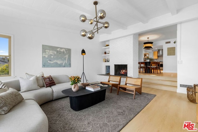 living room with wood-type flooring, a fireplace, and beam ceiling