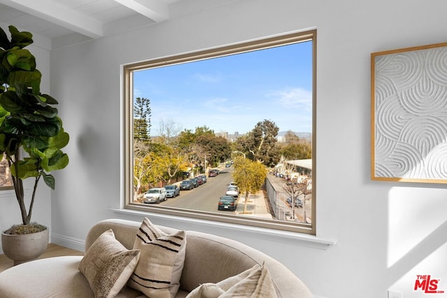 sitting room featuring beam ceiling