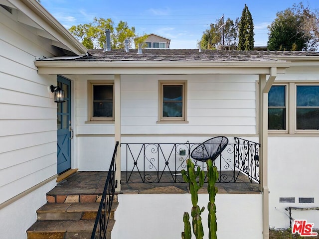 view of exterior entry with covered porch