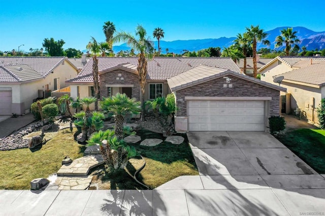 view of front of property featuring a garage and a mountain view