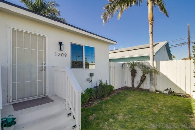 doorway to property featuring a yard