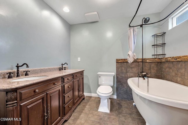 full bathroom with vanity, tile patterned flooring, toilet, and separate shower and tub