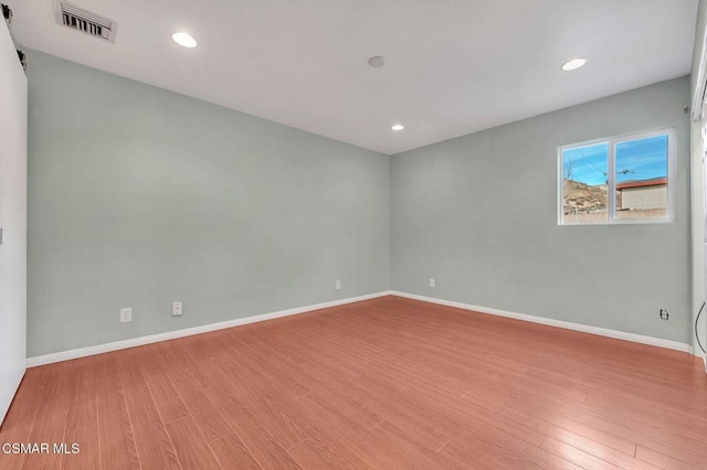 spare room with light hardwood / wood-style floors