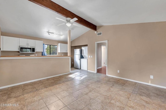 kitchen featuring white cabinetry, ceiling fan, stainless steel appliances, and lofted ceiling with beams