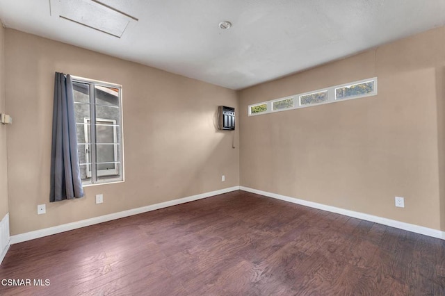 spare room with dark hardwood / wood-style floors