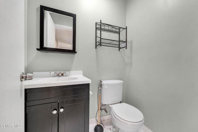 bathroom featuring vanity, tile patterned flooring, and toilet