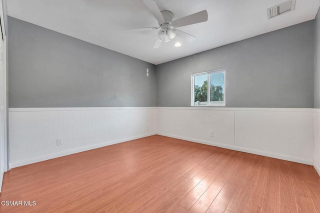 spare room featuring light hardwood / wood-style floors and ceiling fan