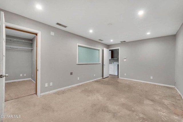 unfurnished bedroom featuring washer and dryer and a closet