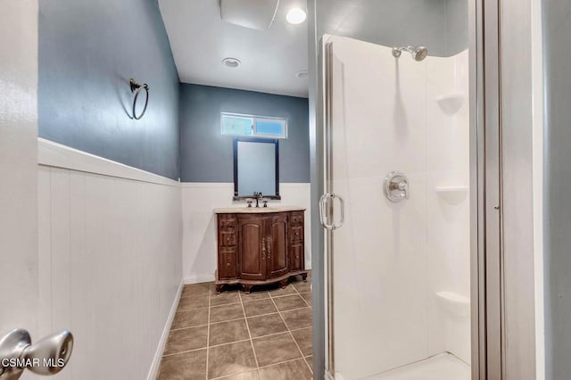 bathroom with vanity, a shower with shower door, and tile patterned flooring