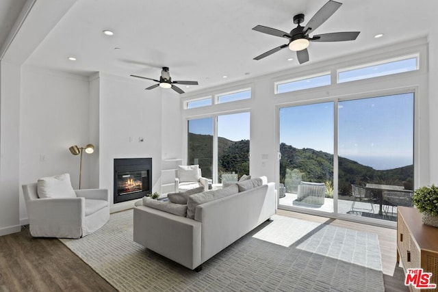 living room with plenty of natural light, a mountain view, and hardwood / wood-style floors