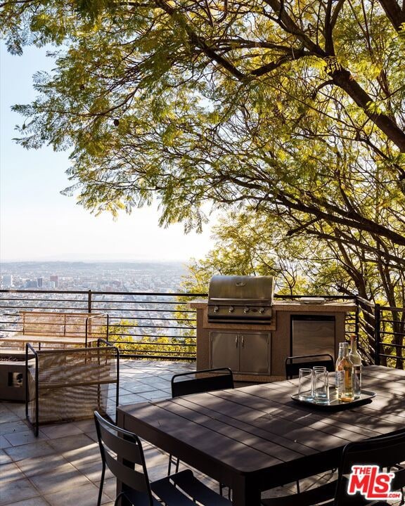 wooden deck featuring a water view and area for grilling