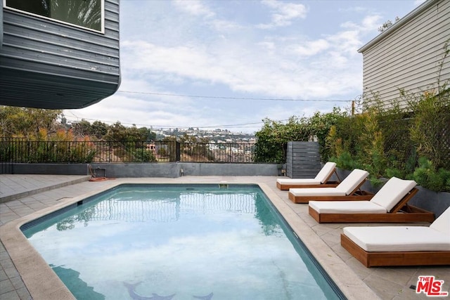 view of swimming pool with a patio area