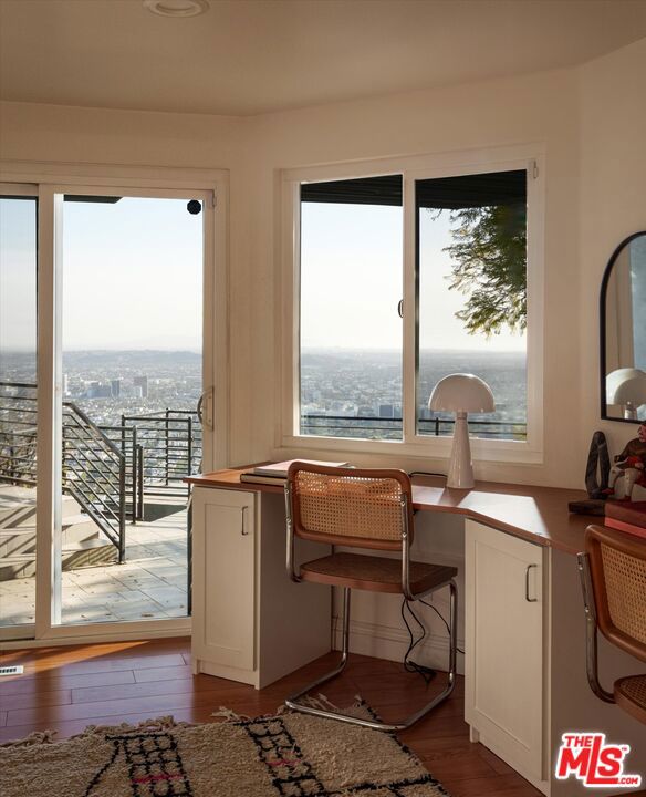 interior space with plenty of natural light and hardwood / wood-style floors