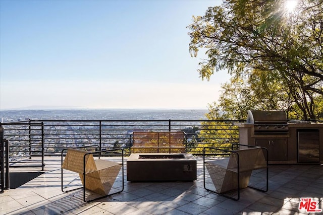 balcony with grilling area, an outdoor fire pit, and area for grilling