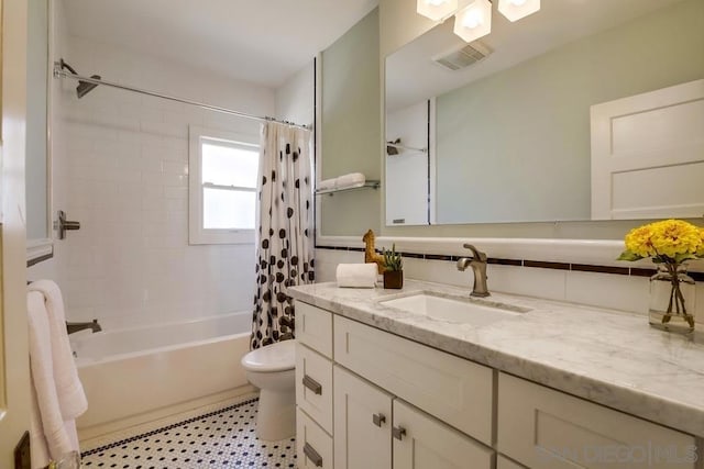 full bathroom featuring vanity, toilet, shower / tub combo, and decorative backsplash