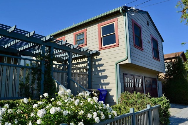 view of side of property with a pergola