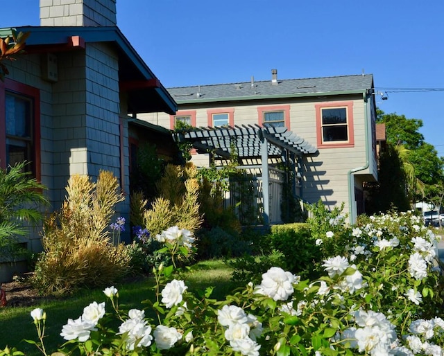 back of property with a pergola