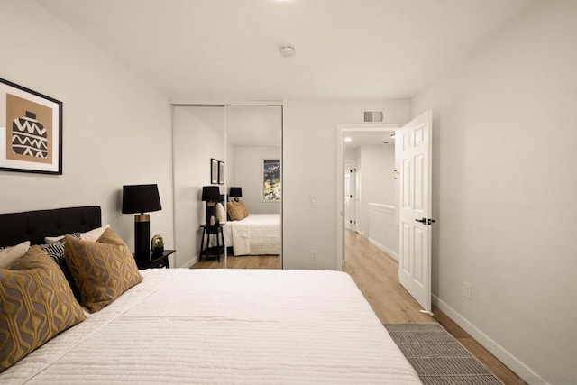 bedroom featuring wood-type flooring and a closet