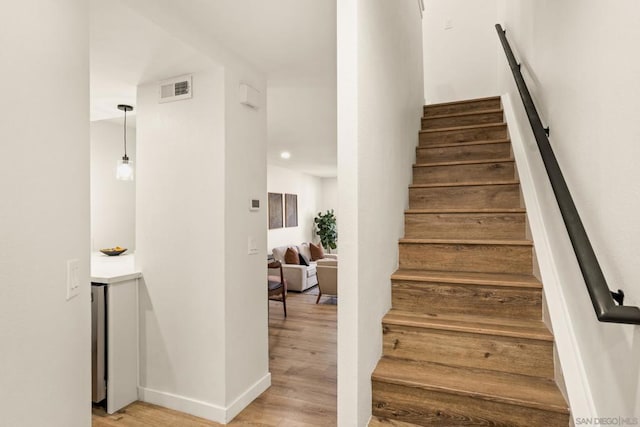 stairway featuring wood-type flooring