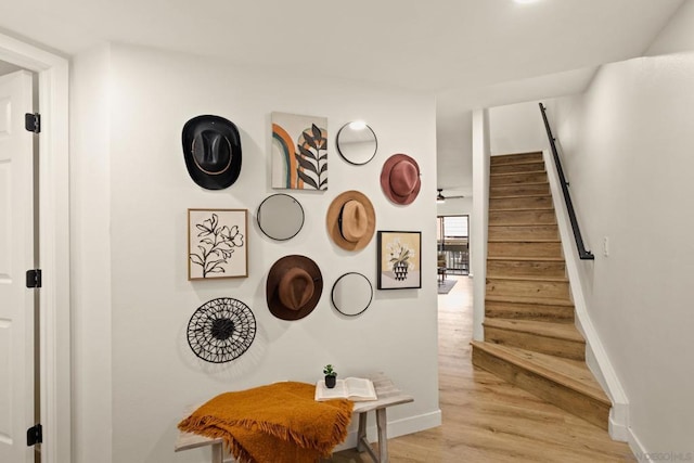 stairs featuring hardwood / wood-style flooring