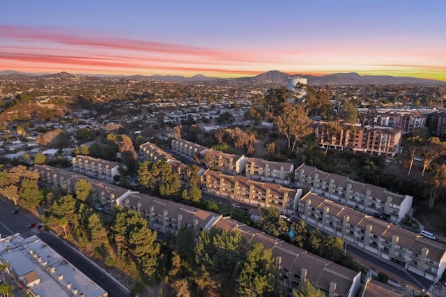 aerial view at dusk featuring a mountain view