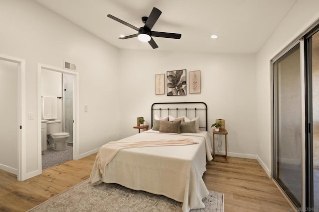 bedroom featuring ceiling fan, access to exterior, ensuite bath, and light hardwood / wood-style flooring