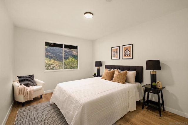 bedroom with hardwood / wood-style floors