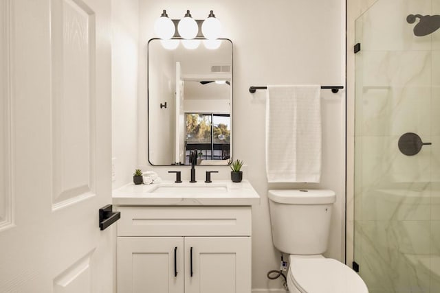 bathroom with vanity, toilet, and walk in shower