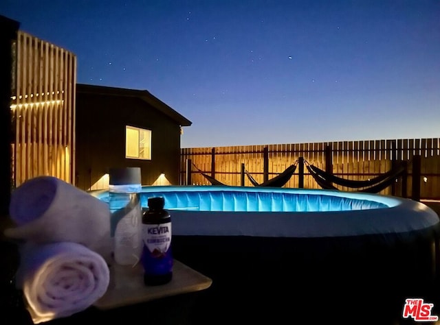 view of pool at dusk