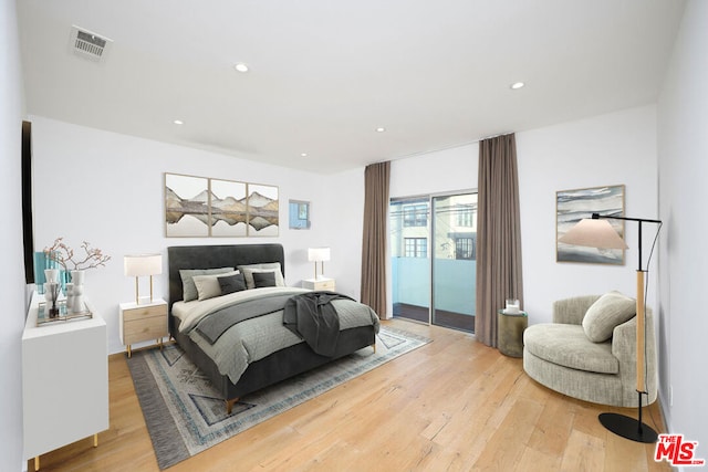 bedroom with access to outside and light hardwood / wood-style floors