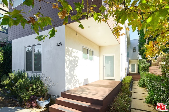 view of property exterior featuring a wooden deck