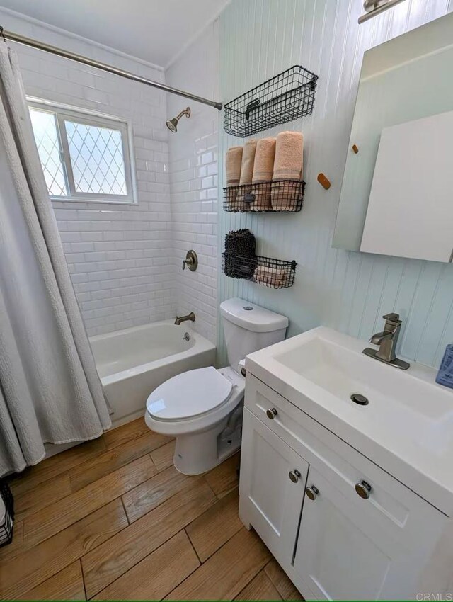 full bathroom with ornamental molding, vanity, toilet, and shower / bath combo with shower curtain