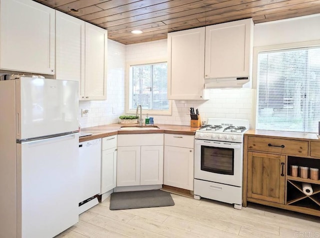 kitchen with sink, white appliances, wooden ceiling, and white cabinets