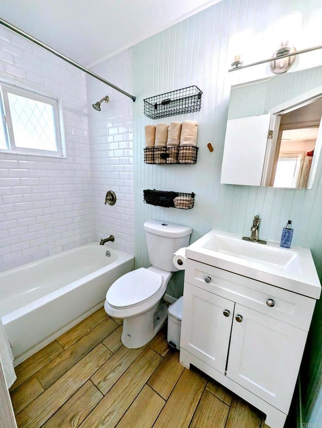 bathroom featuring vanity, toilet, tub / shower combination, and wood finish floors