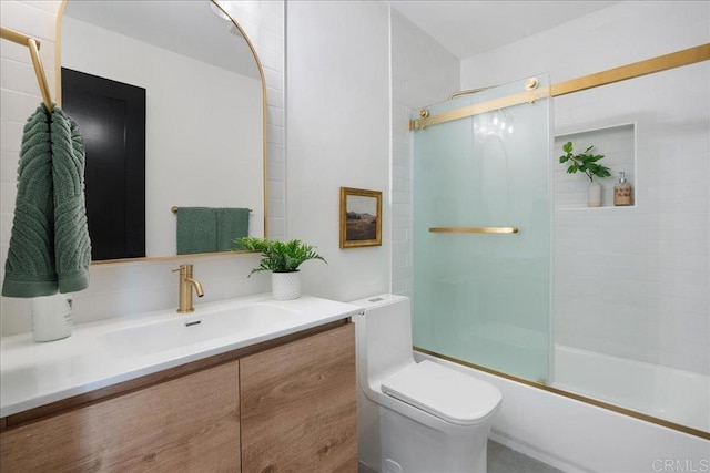 full bathroom with vanity, shower / bath combination with glass door, and toilet