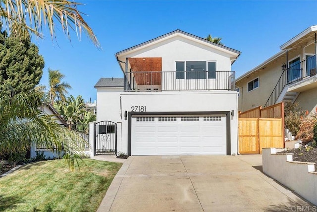 view of front of home featuring a garage, a balcony, and a front lawn