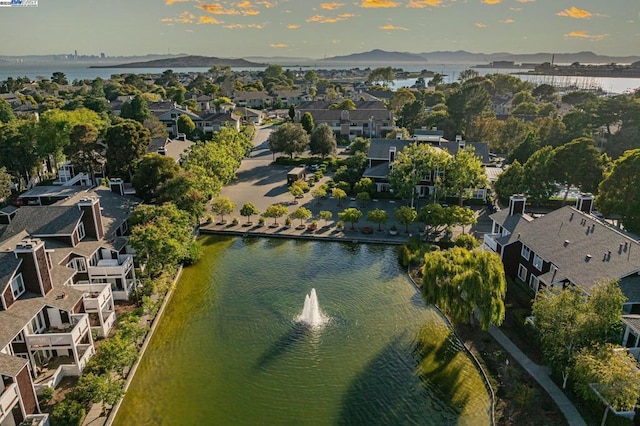 birds eye view of property featuring a water and mountain view