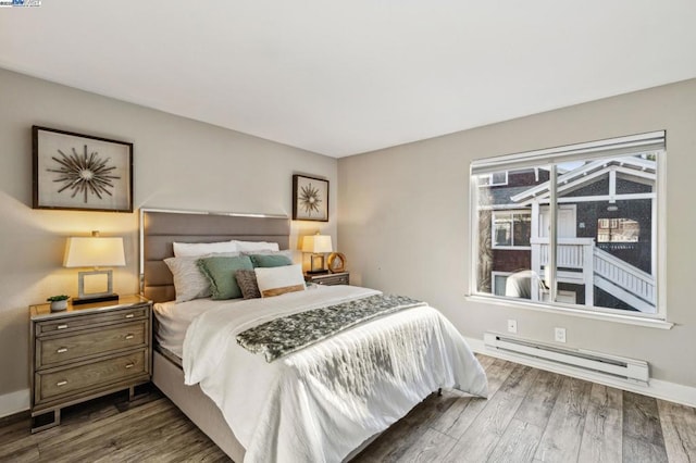 bedroom featuring a baseboard radiator and dark hardwood / wood-style floors