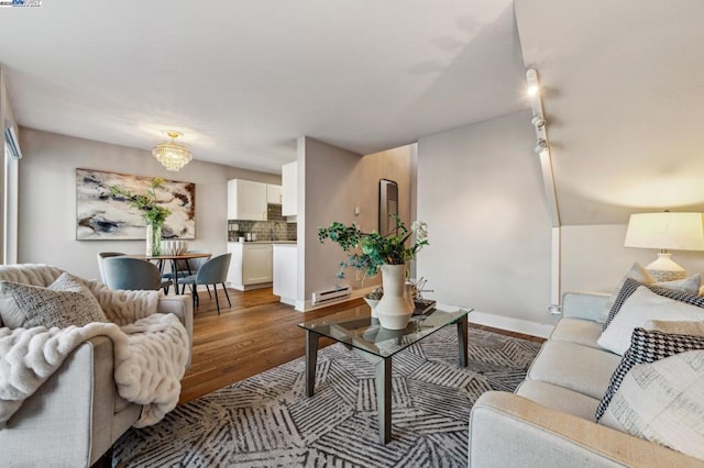 living room with hardwood / wood-style flooring and track lighting