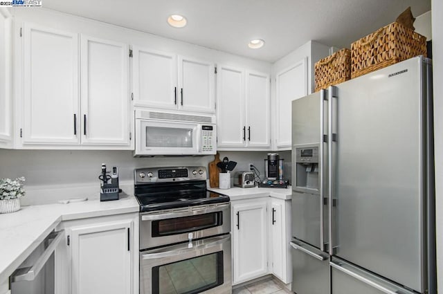 kitchen with white cabinetry, appliances with stainless steel finishes, and light tile patterned floors